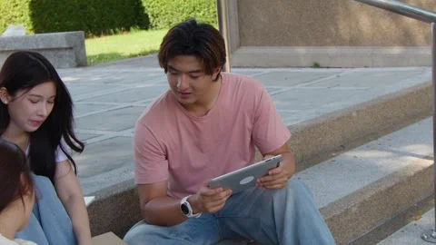 Asian University Students Using Tablet Computer on Campus Stairs Outdoors Stock Footage 340252095