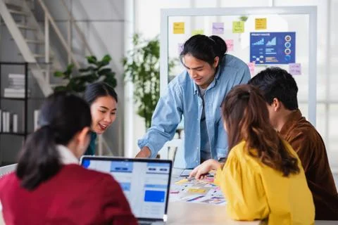 Asian ux developer and ui designer brainstorming about mobile app interface w Stock Photos