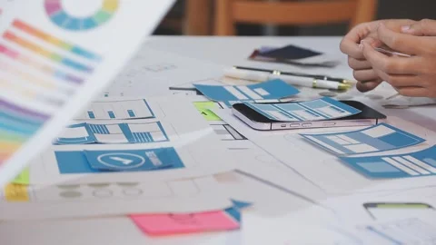 Asian uxui designer working on website design using sticky notes and wirefram Stock Footage 332275211