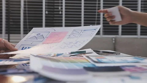 Asian uxui designer working on website design using sticky notes and wirefram Stock Footage 332275253