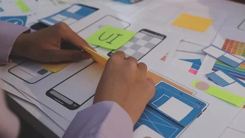Asian uxui designer working on website design using sticky notes and wirefram Stock Footage 332275328