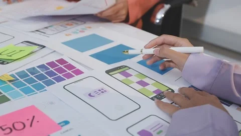 Asian uxui designer working on website design using sticky notes and wirefram Stock Footage 332275486