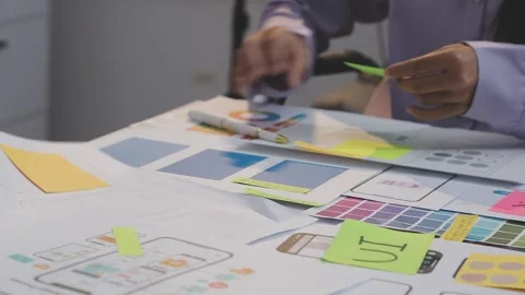 Asian uxui designer working on website design using sticky notes and wirefram Stock Footage 332275495