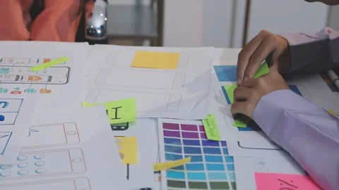 Asian uxui designer working on website design using sticky notes and wirefram Stock Footage 332275498