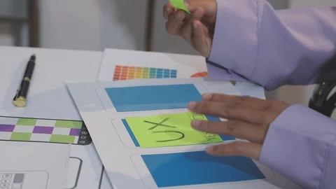Asian uxui designer working on website design using sticky notes and wirefram Stock Footage 332275576