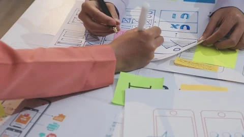 Asian uxui designer working on website design using sticky notes and wirefram Stock Footage 332275597