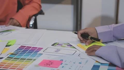 Asian uxui designer working on website design using sticky notes and wirefram Stock Footage 332275604