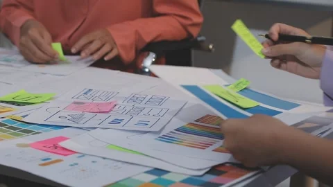 Asian uxui designer working on website design using sticky notes and wirefram Stock Footage 332275638