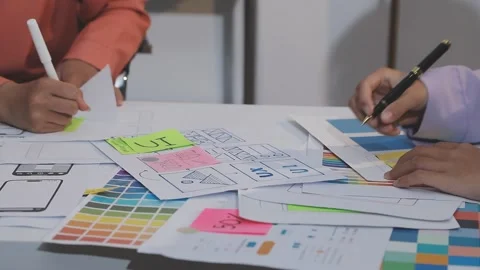 Asian uxui designer working on website design using sticky notes and wirefram Stock Footage 332275685