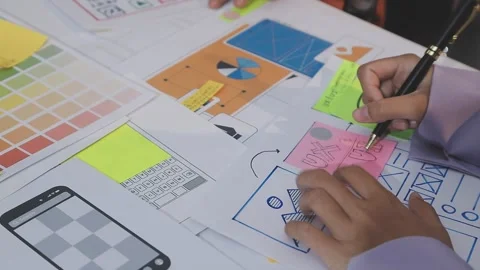 Asian uxui designer working on website design using sticky notes and wirefram Stock Footage 332275738