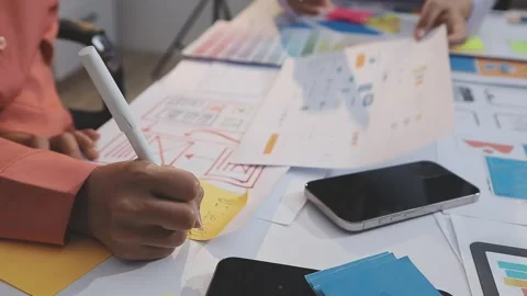 Asian uxui designer working on website design using sticky notes and wirefram Stock Footage 332275769