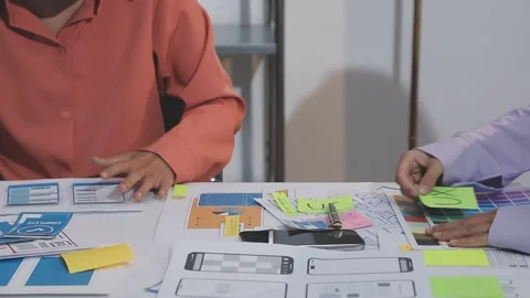 Asian uxui designer working on website design using sticky notes and wirefram Stock Footage 332275834
