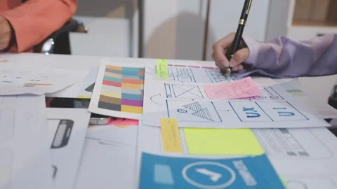 Asian uxui designer working on website design using sticky notes and wirefram Stock Footage 332276030