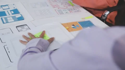 Asian uxui designer working on website design using sticky notes and wirefram Stock Footage 332276038