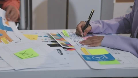 Asian uxui designer working on website design using sticky notes and wirefram Stock Footage 332276042