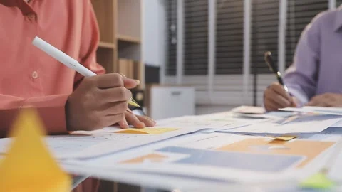 Asian uxui designer working on website design using sticky notes and wirefram Stock Footage 332276092
