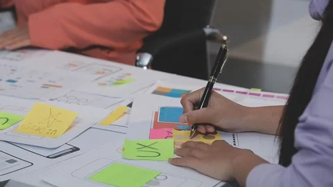 Asian uxui designer working on website design using sticky notes and wirefram Stock Footage 332276156