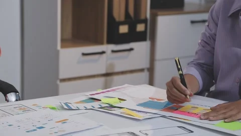 Asian uxui designer working on website design using sticky notes and wirefram Stock Footage 332276164