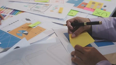 Asian uxui designer working on website design using sticky notes and wirefram Stock Footage 332276288