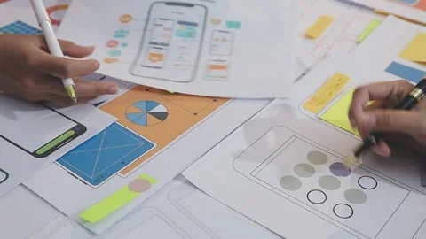 Asian uxui designer working on website design using sticky notes and wirefram Stock Footage 332276331
