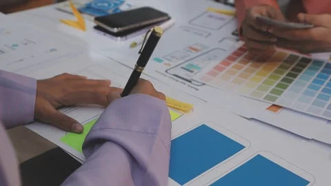 Asian uxui designer working on website design using sticky notes and wirefram Stock Footage 332276333