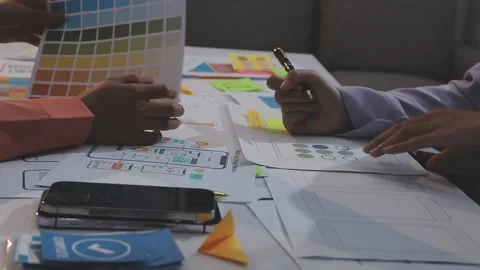 Asian uxui designer working on website design using sticky notes and wirefram Stock Footage 332276367