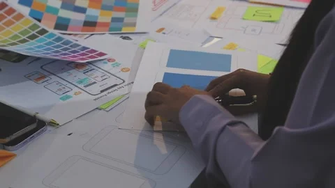 Asian uxui designer working on website design using sticky notes and wirefram Stock Footage 332276389