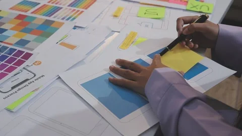 Asian uxui designer working on website design using sticky notes and wirefram Stock Footage 332276403