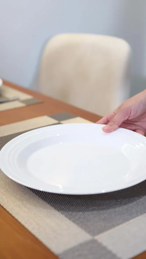 Asian Waiter Placing Empty White Ceramic Plate on Restaurant Dining Table Stock Footage 335807811