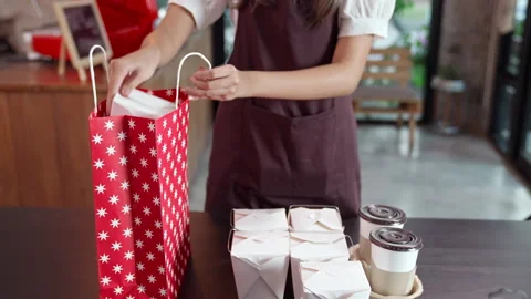 Asian Waitress Preparing order for take away customer.Slow motion Dolly shop Stock Footage 144390317