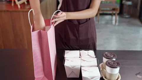 Asian Waitress Preparing order for take away customer.Slow motion Dolly shop  Stock Footage 146884117