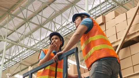 Asian warehouse two workers checking stock on the shelves. Stock Footage 143956913
