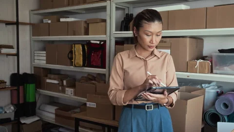 Asian Warehouse Worker Using Tablet while Checking Parcels 스톡 동영상 281715451