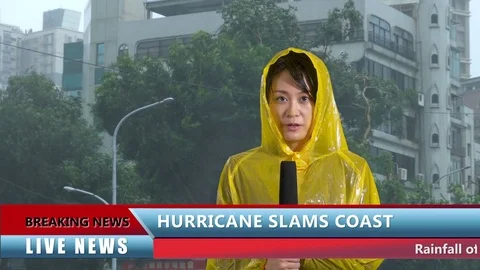 Asian weather reporter in hurricane with lower thirds mock news report Stock Footage