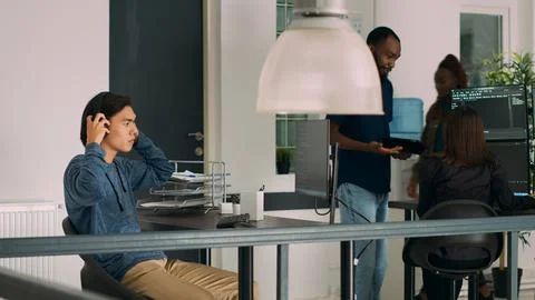 Asian web developer programming firewall server on terminal window Stockfoto's