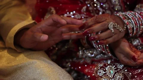 Asian wedding, bride places ring on grooms finger 動画素材 41445962