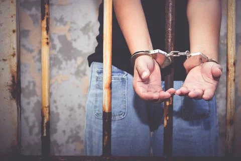 Asian woman in black In captivity, handcuffed Ask for help. Stock Photos