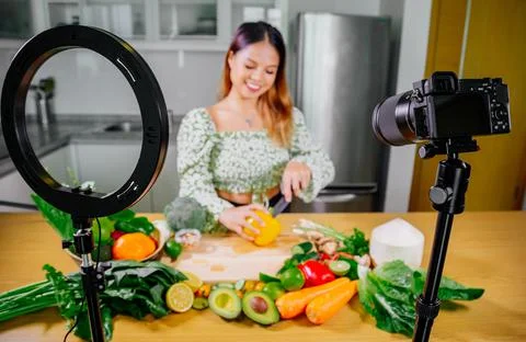 Asian woman blogger or content creator cooking and recording video camera Stock Photos