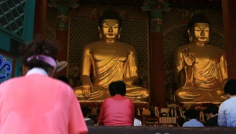 Asian woman bowing down to pray Buddha in temple Stock Footage