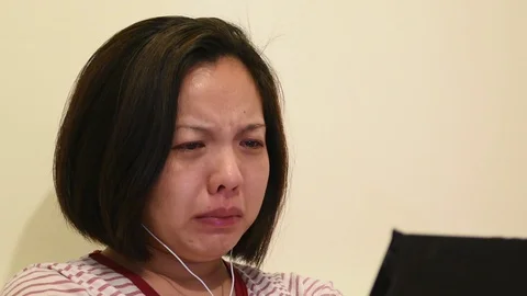Asian woman crying by watching dramatic series TV in smartphone Video stock 129084006