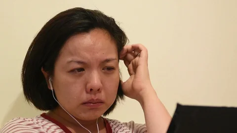 Asian woman crying by watching dramatic series TV in smartphone Video stock 129084009