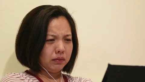 Asian woman crying by watching dramatic series TV in smartphone Video stock 129084015