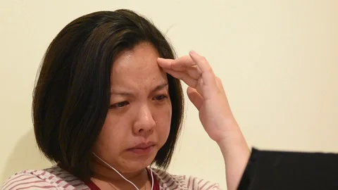 Asian woman crying by watching dramatic series TV in smartphone Video stock 129084034