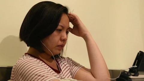 Asian woman crying by watching dramatic series TV in smartphone Video stock 129084097