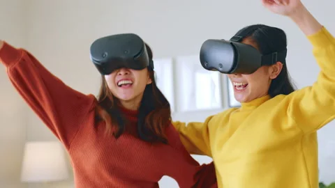 Asian woman dancing while using 360 VR headset for virtual reality, metaverse Stock Footage 190466213