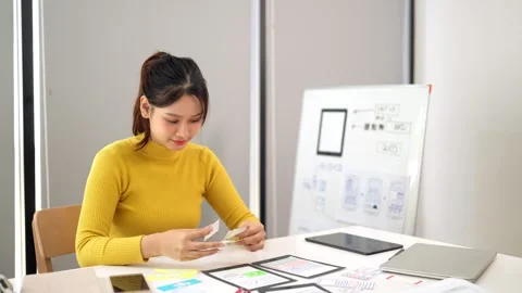 Asian Woman Designing User Interface Layout for Mobile Application Website .. Stock Footage 333470364