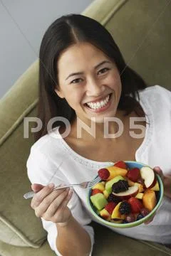 Asian Woman Eating Fruit Salad