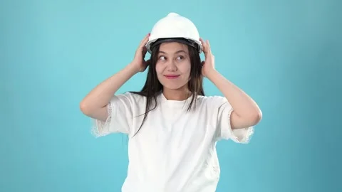 Asian Woman Engineer Feeling Relieved and Smiling Against Blue Background Stock Footage 344782333