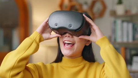 Asian woman excited while using 360 VR headset for virtual reality, metaverse Stock Footage 190686226