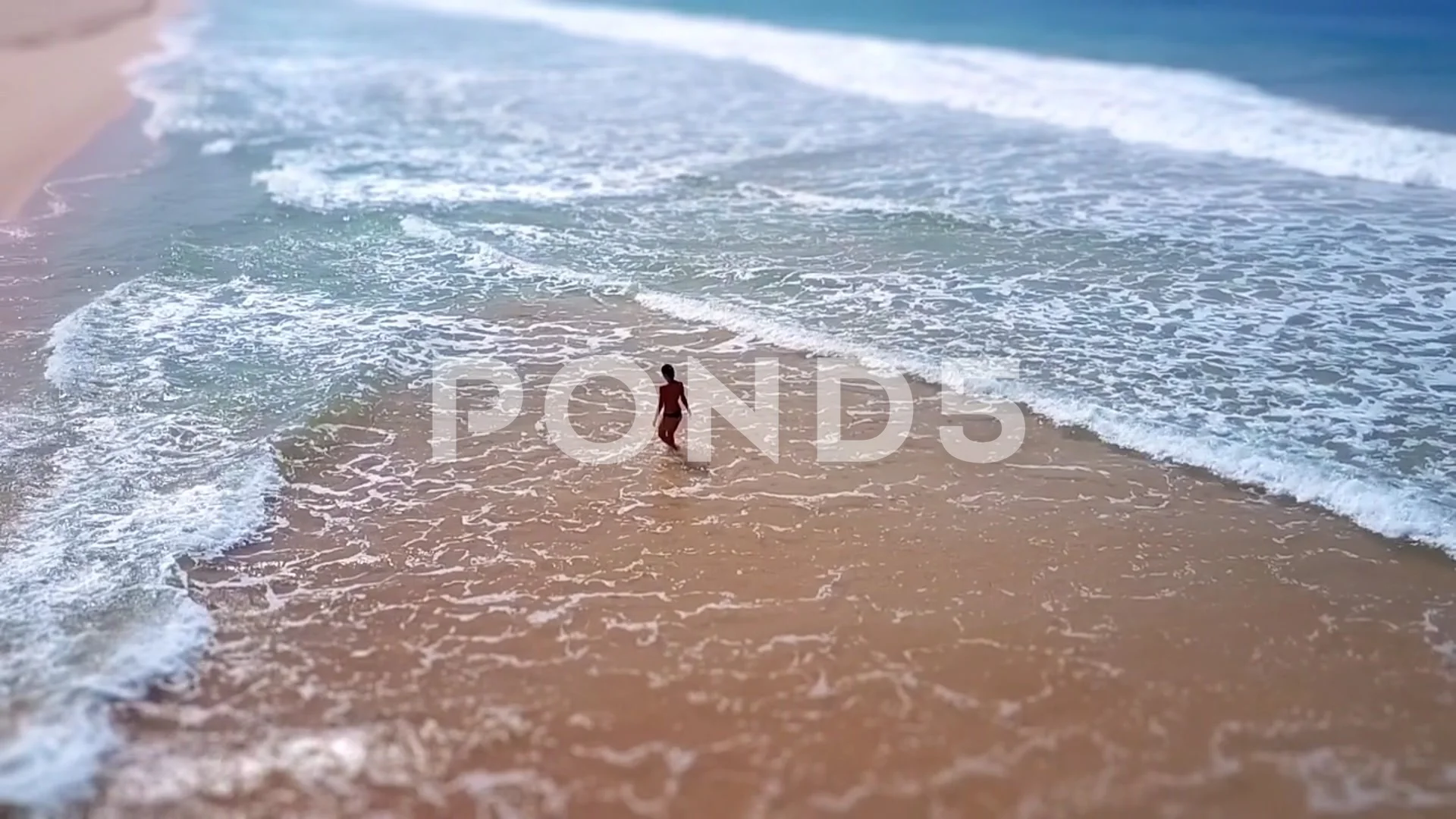 Asian woman feet walking barefoot beach golden sunset leaving footprints  sand